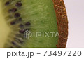 Kiwi cut in half close up 73497220