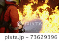 Firefighter using Chemical foam fire extinguisher to fighting with the fire flame from oil tanker truck accident. Firefighter safety disaster accident and public service concept. 73629396