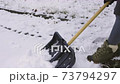 Woman start removing snow with shovel.Winter concept  73794297