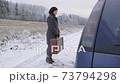 Woman hitchhiker with vintage suitcase refuses from stranger car 73794298