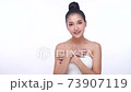 Portrait of smile young woman holding applying cosmetic cream or treatment moisturize in her body 73907119