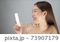 Portrait of smile young woman holding products cosmetic cream or treatment moisturize in her hand 73907179
