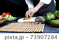 Close-up hand of professional chef man holding fried agricultural protein and slicing  73907284