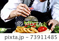 Close up hand of chef process of making set vegetarian hamburger on table 73911485