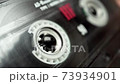 Retro audio tape copmact cassette is playing music. 73934901