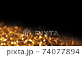 Abstract luxury background with golden glitter lights on black. Depth of field particles. Seamless loop animation of sparkling gltters.  74077894