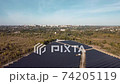 Solar energy farm. High angle, elevated view of solar panels on an energy farm far from city. aerial view on solar panels. 74205119