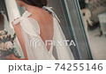 Close-up view of young girl model posing in white wedding dress for fashion shooting indoors. 74255146