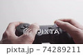User playing video games with playstation dualshock gamepad controller 74289211
