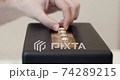 Adjusting bluetooth speaker settings - Fingers turning control knobs for audio settings on a modern vintage bluetooth loudspeaker - treble, mids, bass 74289215