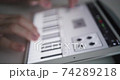 Musician playing piano on a tablet software for music creation - defocused concept footage 74289218