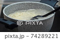 Cooking spaghetti in a stone saucepan 74289221