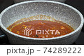 Tomato sauce stewing in stone saucepan - pasta sauce recipe 74289222