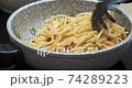 Preparing spaghetti with tomato red sauce in a saucepan 74289223