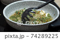 Cooking garlic green sauce in a stone pan 74289225
