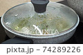 Stewing a dish in stone saucepan 74289226