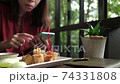 Young woman having breakfast in coffee shop. 74331808