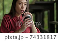 Woman drinking iced tea in cafe. 74331817