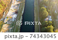 Flying above the water channel in the forest. Drone aerial footage 74343045