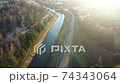 Flying above the water channel in the forest. Drone aerial footage 74343064