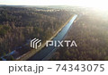 Flying above the water channel in the forest. Drone aerial footage 74343075