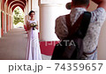 Professional wedding photographer taking portraits of young beautiful bride near the columns 74359657