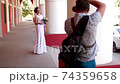 Professional wedding photographer taking portraits of young beautiful bride near the columns 74359658