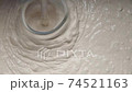 Slow motion pan shot of mixing concrete plaster 74521163
