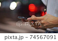 Body parts at hand for women who use smartphones in the crowd (night, cityscape, city) 74567091