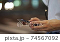 Body parts at hand for women who use smartphones in the crowd (night, cityscape, city) 74567092