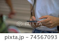 Body parts at hand for women who use smartphones in the crowd (night, cityscape, city) 74567093
