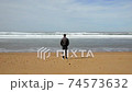 Cinemagraph of man at beach contemplating the sea 74573632