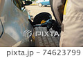 Hand refilling the car with fuel at the refuel station 74623799