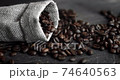 Coffee beans scattered from a linen bag on a wooden table. Fresh roasted arabica coffee beans. Espresso, americano, doppio, cappuccino, latte. Robusta. Selective focus. 74640563