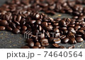 Roasted arabica coffee beans scattered on a wooden table. Fresh coffee beans. Espresso, americano, doppio, cappuccino, latte. Robusta. Selective focus. 74640564