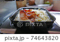 Swiss raclette : hot cheese and bacon 74643820