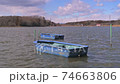 A boat floating on a lake 74663806