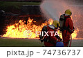 FHD Slow motion: Firefighter using Chemical foam fire extinguisher to fighting with the fire flame from oil tanker truck accident. Firefighter safety disaster accident and public service concept. 74736737