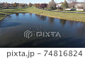Overhead aerial view of relaxing and swimming Canadian geese on a pond surface. American suburban neighborhood. 4K 74816824