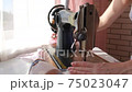 girl sews on an old retro hand sewing machine 75023047