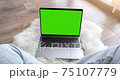 Green screen laptop computer sitting on a home work 75107779