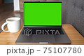 Green screen laptop computer sitting on a home work 75107780