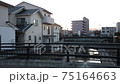 The light of the sun setting in the city 75164663