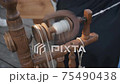 Producing homespun wool yarn on a spinning wheel 75490438