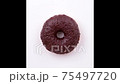 Eating a chocolate donut. 75497720