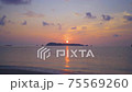 A sunrise over the beach of Yasuda, which is rich in nature in the northern part of the main island of Okinawa. You can see the uninhabited island of Adaga Island in front of you. 75569260
