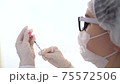Closeup doctor fills the syringe with the coronavirus vaccine from the ampoule. Concept of treatment of coronavirus infection, COVID-19 vaccination. 4k 75572506
