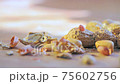 Detail of shell peanuts and out with pieces of shell falling from above Detail of shell peanuts and out with pieces of shell falling from above 75602756