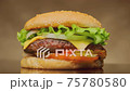 Yummy juicy cheeseburger with meat cutlet, cheese and fresh vegetables rotating on table close-up. Delicious beef burger from chef. 75780580