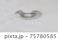 Soapy water  flows down drain through hole in sink in bathroom close up, top view. 75780585